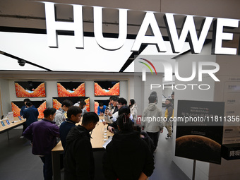 Customers experience the newly released Huawei Mate70 phone at a Huawei store in Nanjing, China, on November 26, 2024. (