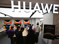 Customers experience the newly released Huawei Mate70 phone at a Huawei store in Nanjing, China, on November 26, 2024. (