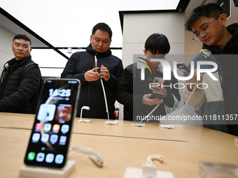 Customers experience the newly released Huawei Mate70 phone at a Huawei store in Nanjing, China, on November 26, 2024. (