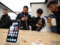 Customers experience the newly released Huawei Mate70 phone at a Huawei store in Nanjing, China, on November 26, 2024. (