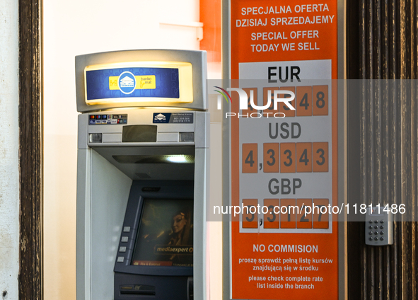 KRAKOW, POLAND - NOVEMBER 21:   
An ATM next to a currency exchange shop displays only selling rates, a longstanding practice in Krakow and...