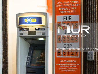 KRAKOW, POLAND - NOVEMBER 21:   
An ATM next to a currency exchange shop displays only selling rates, a longstanding practice in Krakow and...