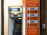 KRAKOW, POLAND - NOVEMBER 21:   
An ATM next to a currency exchange shop displays only selling rates, a longstanding practice in Krakow and...