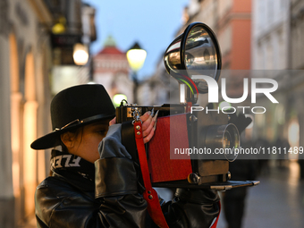 KRAKOW, POLAND - NOVEMBER 21:   
A photographer from Old Press, the first instant newspaper ever, seen on Krakow's Florianska Street, on Nov...