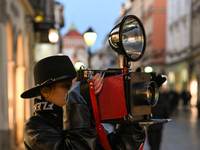 KRAKOW, POLAND - NOVEMBER 21:   
A photographer from Old Press, the first instant newspaper ever, seen on Krakow's Florianska Street, on Nov...