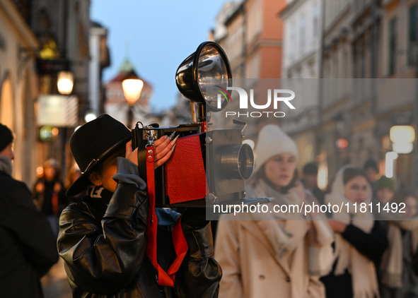 KRAKOW, POLAND - NOVEMBER 21:   
A photographer from Old Press, the first instant newspaper ever, seen on Krakow's Florianska Street, on Nov...