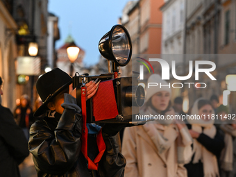 KRAKOW, POLAND - NOVEMBER 21:   
A photographer from Old Press, the first instant newspaper ever, seen on Krakow's Florianska Street, on Nov...