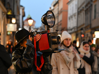 KRAKOW, POLAND - NOVEMBER 21:   
A photographer from Old Press, the first instant newspaper ever, seen on Krakow's Florianska Street, on Nov...