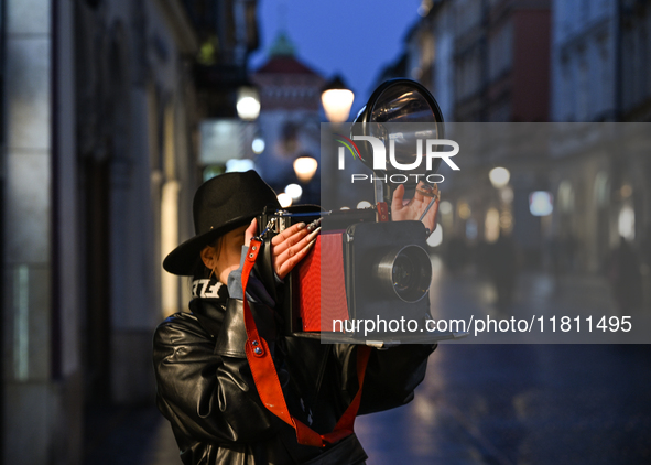 KRAKOW, POLAND - NOVEMBER 21:   
A photographer from Old Press, the first instant newspaper ever, seen on Krakow's Florianska Street, on Nov...