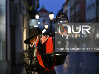 KRAKOW, POLAND - NOVEMBER 21:   
A photographer from Old Press, the first instant newspaper ever, seen on Krakow's Florianska Street, on Nov...