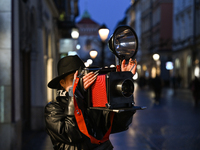 KRAKOW, POLAND - NOVEMBER 21:   
A photographer from Old Press, the first instant newspaper ever, seen on Krakow's Florianska Street, on Nov...