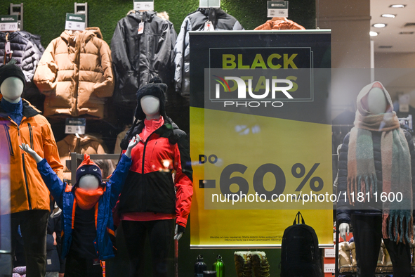 KRAKOW, POLAND - NOVEMBER 21:   
A 'Black Deal Up to 60%' poster displayed in the window of The Mountain Warehouse store, on November 21, 20...