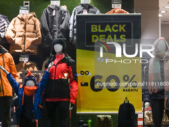 KRAKOW, POLAND - NOVEMBER 21:   
A 'Black Deal Up to 60%' poster displayed in the window of The Mountain Warehouse store, on November 21, 20...