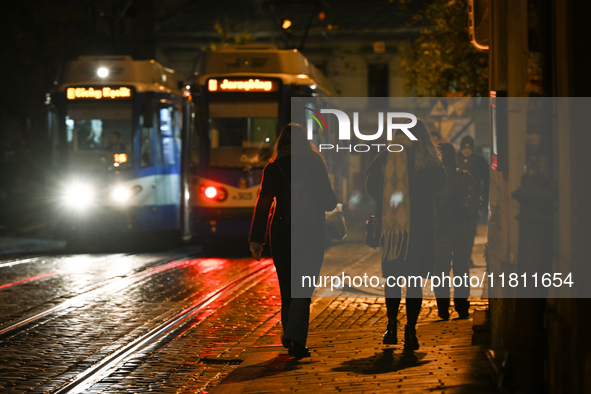 KRAKOW, POLAND - NOVEMBER 21:   
A winter evening view of crossing tramways near Krakow's Old Town, illuminated by streetlights, on November...