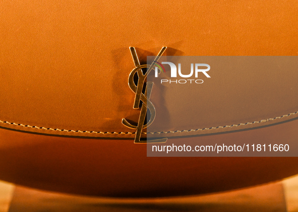 KRAKOW, POLAND - NOVEMBER 21:   
A logo of YSL on a new bag from the latest Yves Saint Laurent collection displayed in a shop window in Krak...