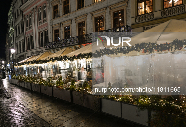 KRAKOW, POLAND - NOVEMBER 21:   
General view of outdoor seating at restaurants in Krakow's Main Market Square, decorated for the Christmas...