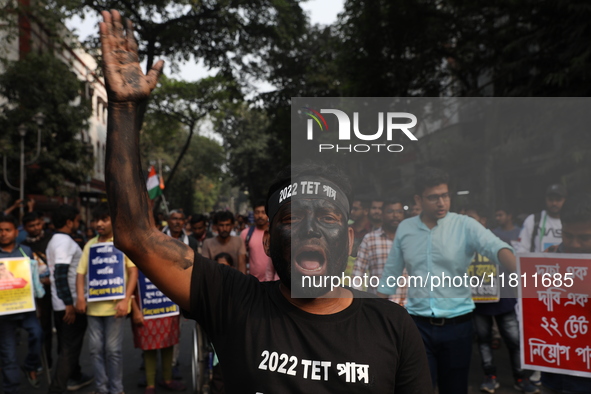 Job seekers and teachers shout slogans demanding the requirement for fifty thousand vacant posts as they take part in a protest march in Kol...