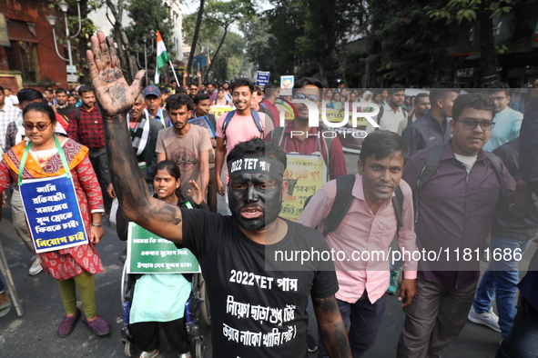 Job seekers and teachers shout slogans demanding the requirement for fifty thousand vacant posts as they take part in a protest march in Kol...