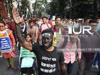 Job seekers and teachers shout slogans demanding the requirement for fifty thousand vacant posts as they take part in a protest march in Kol...