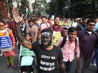 Job seekers and teachers shout slogans demanding the requirement for fifty thousand vacant posts as they take part in a protest march in Kol...