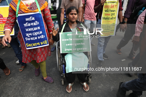 Job seekers and teachers shout slogans demanding the requirement for fifty thousand vacant posts as they take part in a protest march in Kol...