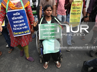 Job seekers and teachers shout slogans demanding the requirement for fifty thousand vacant posts as they take part in a protest march in Kol...