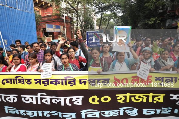 Job seekers and teachers shout slogans demanding the requirement for fifty thousand vacant posts as they take part in a protest march in Kol...