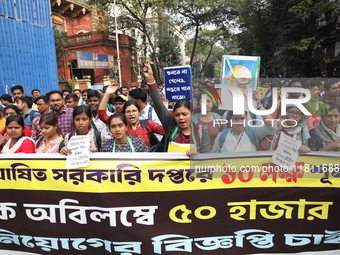 Job seekers and teachers shout slogans demanding the requirement for fifty thousand vacant posts as they take part in a protest march in Kol...