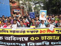 Job seekers and teachers shout slogans demanding the requirement for fifty thousand vacant posts as they take part in a protest march in Kol...