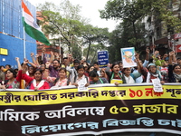 Job seekers and teachers shout slogans demanding the requirement for fifty thousand vacant posts as they take part in a protest march in Kol...