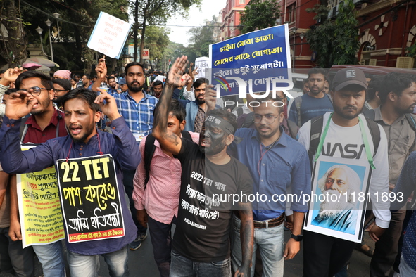 Job seekers and teachers shout slogans demanding the requirement for fifty thousand vacant posts as they take part in a protest march in Kol...