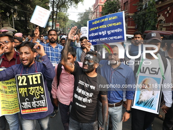 Job seekers and teachers shout slogans demanding the requirement for fifty thousand vacant posts as they take part in a protest march in Kol...