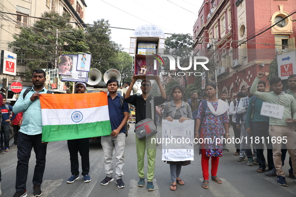 Job seekers and teachers shout slogans demanding the requirement for fifty thousand vacant posts as they take part in a protest march in Kol...