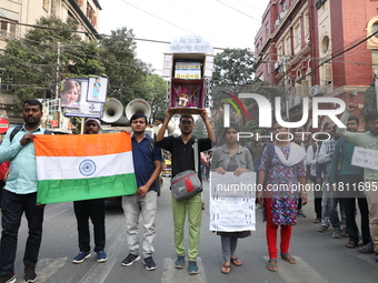 Job seekers and teachers shout slogans demanding the requirement for fifty thousand vacant posts as they take part in a protest march in Kol...