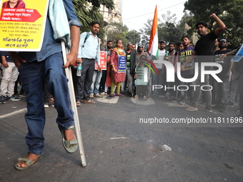 Job seekers and teachers shout slogans demanding the requirement for fifty thousand vacant posts as they take part in a protest march in Kol...