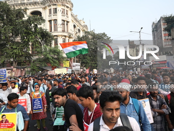 Job seekers and teachers shout slogans demanding the requirement for fifty thousand vacant posts as they take part in a protest march in Kol...