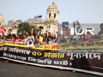 Job seekers and teachers shout slogans demanding the requirement for fifty thousand vacant posts as they take part in a protest march in Kol...