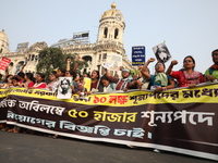 Job seekers and teachers shout slogans demanding the requirement for fifty thousand vacant posts as they take part in a protest march in Kol...