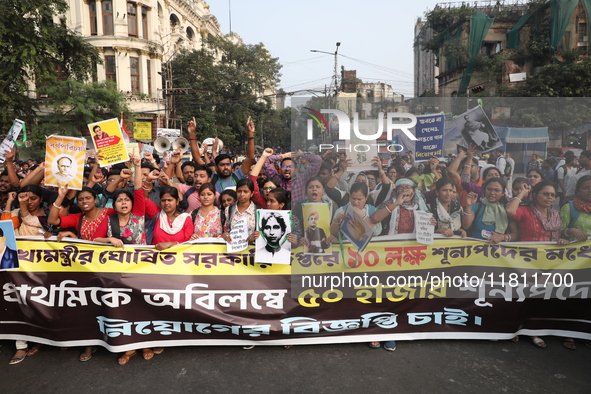 Job seekers and teachers shout slogans demanding the requirement for fifty thousand vacant posts as they take part in a protest march in Kol...