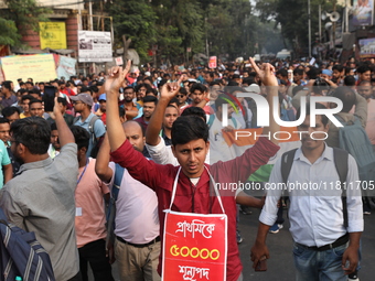 Job seekers and teachers shout slogans demanding the requirement for fifty thousand vacant posts as they take part in a protest march in Kol...