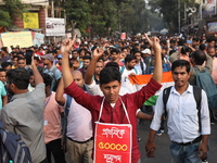 Job seekers and teachers shout slogans demanding the requirement for fifty thousand vacant posts as they take part in a protest march in Kol...