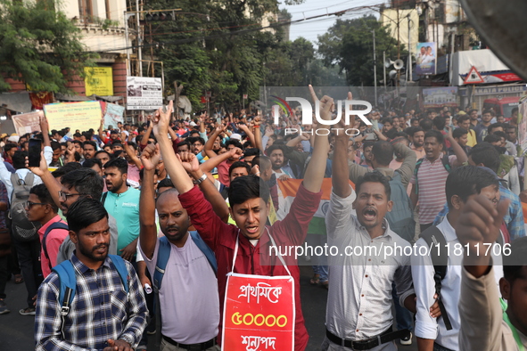 Job seekers and teachers shout slogans demanding the requirement for fifty thousand vacant posts as they take part in a protest march in Kol...