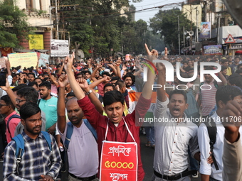 Job seekers and teachers shout slogans demanding the requirement for fifty thousand vacant posts as they take part in a protest march in Kol...