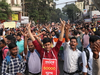 Job seekers and teachers shout slogans demanding the requirement for fifty thousand vacant posts as they take part in a protest march in Kol...