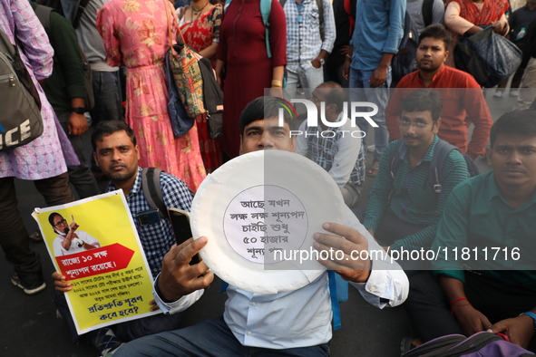 Job seekers and teachers shout slogans demanding the requirement for fifty thousand vacant posts as they take part in a protest march in Kol...