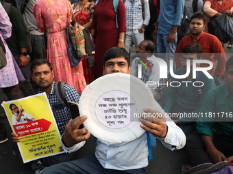 Job seekers and teachers shout slogans demanding the requirement for fifty thousand vacant posts as they take part in a protest march in Kol...