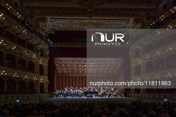 The London Philharmonic Orchestra, conducted by Alessandro Crudele, performs at the historic Teatro Petruzzelli in Bari, Italy, on November...