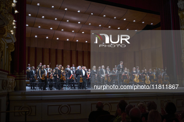 The London Philharmonic Orchestra, conducted by Alessandro Crudele, performs at the historic Teatro Petruzzelli in Bari, Italy, on November...