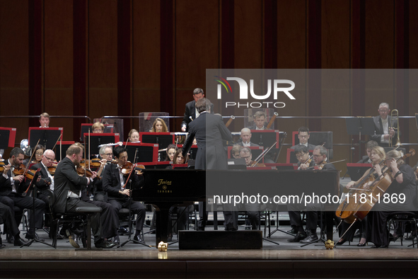 The London Philharmonic Orchestra, conducted by Alessandro Crudele, performs at the historic Teatro Petruzzelli in Bari, Italy, on November...