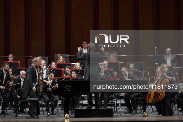 The London Philharmonic Orchestra, conducted by Alessandro Crudele, performs at the historic Teatro Petruzzelli in Bari, Italy, on November...